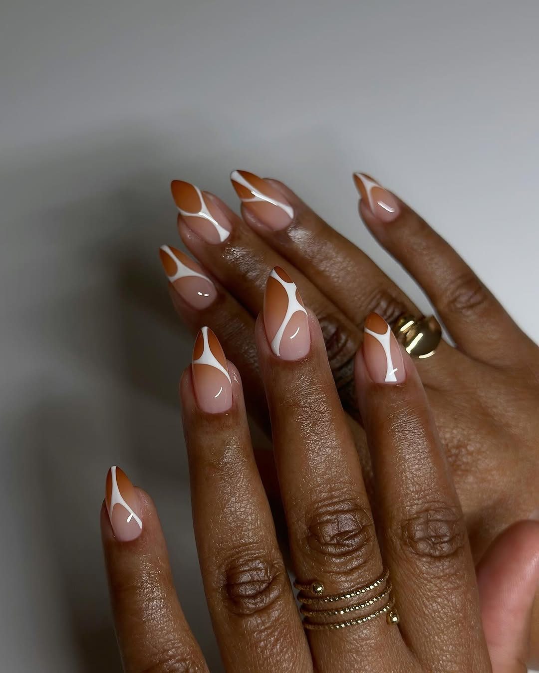 Brown glossy stiletto nails