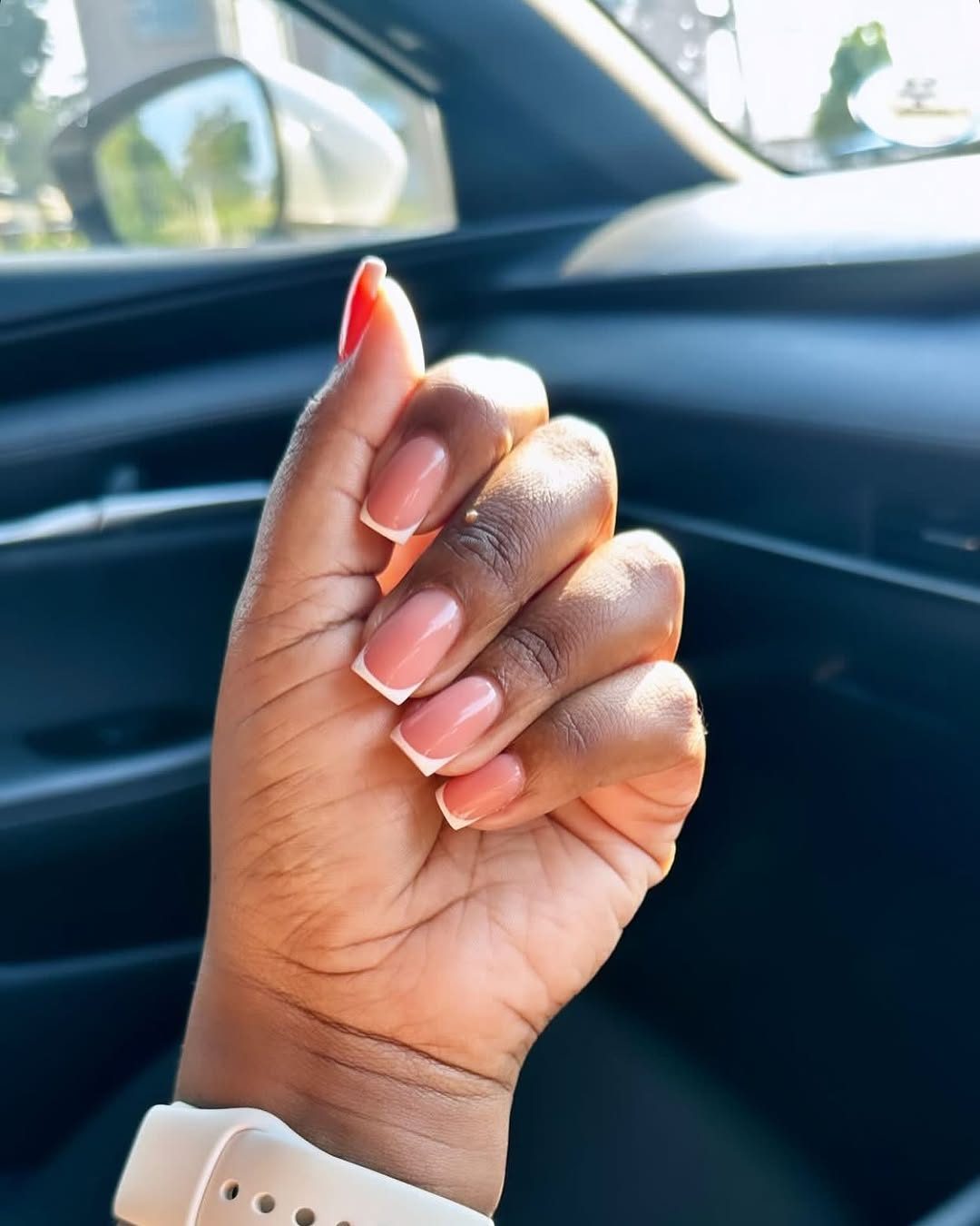 Nude pink manicure in car